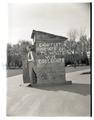 Walter Quincy posing with a prop created by the Collegiate Party for use during ASOSC election season