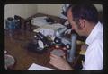 Superintendent Porter Lombard at microscope, Southern Oregon Experiment Station, Medford, Oregon, 1975