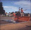 Steeplechase runners negotiate the water hazard at Bell Field