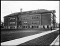 Side view, Irvington School, with student on foreground sidewalk.