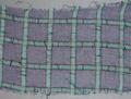 Textile fragment of navy blue chiffon with windowpane plaid in green with red stripe