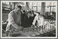 Ernest Wiegand (left) and others testing canned berries, Food Technology Building Canning Lab, circa 1940