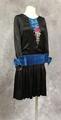 Dress of black silk satin and blue velvet with accents of yarn embroidered flowers