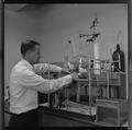Faculty with white rat used in rocket fuel experiment at the Science Research Institute, 1964
