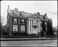 A. L. Mills residence, 20th St., Portland. Large brick house surrounded by low wall. Street in foreground.