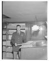 An unidentified OSC alum wearing a military uniform and holding a slide rule