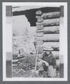 John F. "Jack" Pernot next to log structure in Ochoco National Forest, circa 1914