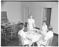 Home Economics students at a formal table setting, January 1954