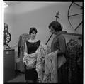 Students examining fabrics in a clothing and textiles research lab, February 1964