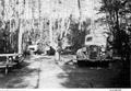 Family shown in campground.  Water pump in foreground