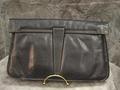 Clutch of navy blue leather with box pleat at center-front