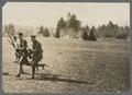 Cadets running with rifles on lower campus, circa 1920