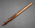 Curling rod of brown varnished wood used for forming ringlets in hair