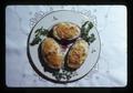 Twice baked potatoes on plate, 1975