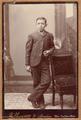 Young man leaning on back of a chair