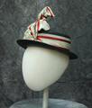 Sailor-style hat of black straw (feels like horse hair) with wide ribbon around brim with unique ribbon design at center-front