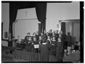 Members of the choir at the Evangelical church enjoy their singing under the direction of Anetta Stroda, December 1950